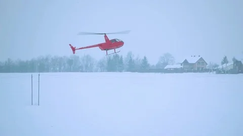 Red helicopter takes off in winter over the power line. Stock Footage 80319145