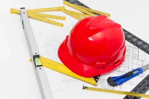 Red Helmet and tools for construction drawings and buildings Stock Photos