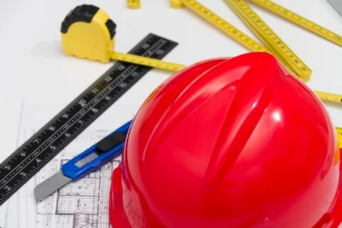Red Helmet and tools for construction drawings and buildings Stock Photos