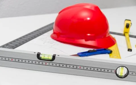 Red Helmet and tools for construction drawings and buildings Stock Photos