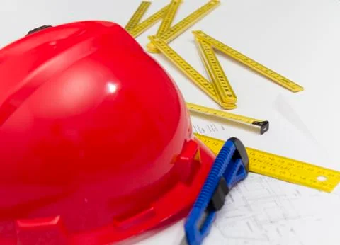 Red Helmet and tools for construction drawings and buildings Stock Photos