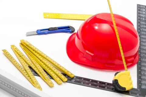 Red Helmet and tools for construction drawings and buildings Stock Photos