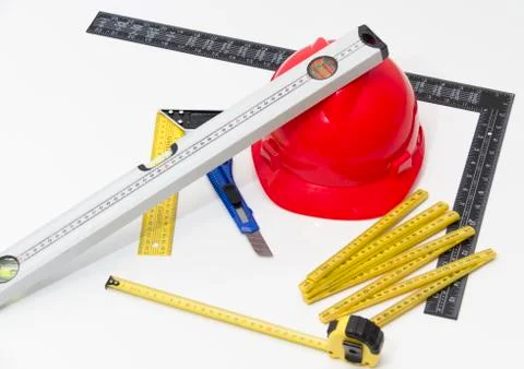 Red Helmet and tools for construction drawings and buildings Stock Photos