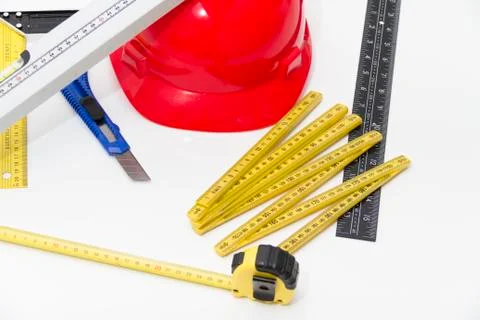Red Helmet and tools for construction drawings and buildings Stock Photos