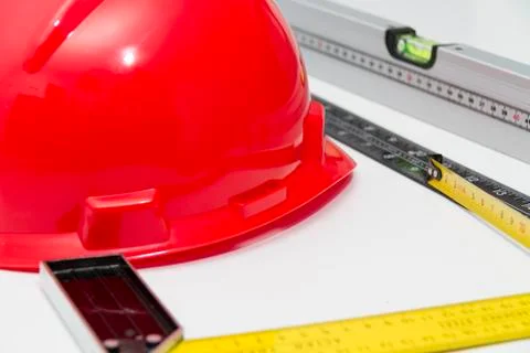 Red Helmet and tools for construction drawings and buildings Stock Photos