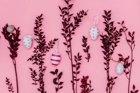 Red herb branches and easter eggs on pink background Stock Photos
