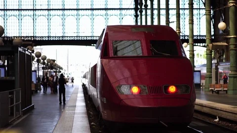 Red high-speed train departing Gare du Nord railway station in Paris, France Video stock 125495929