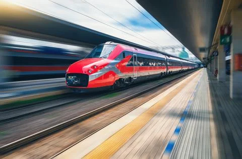Red high speed train in motion on the railway station Stock Photos