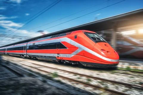 Red high speed train in motion on the railway station Stock Photos