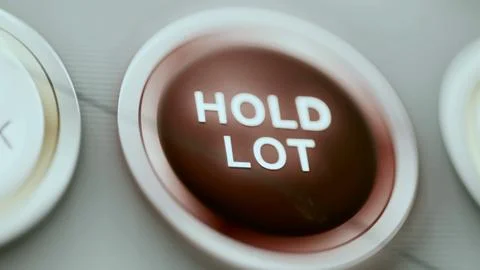 Red hold lot button dominates dark panel Stock Photos