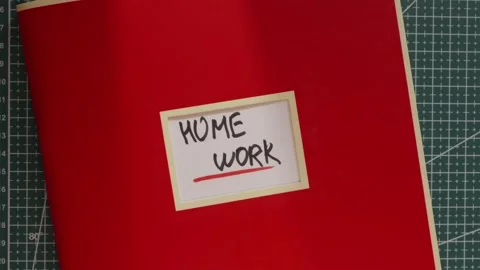 Red Home Work workbook folder on wooden desk background Stock Footage 341269398