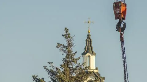 Red hook of a crane on the background of the tower church with orthodox cross Stock Photos