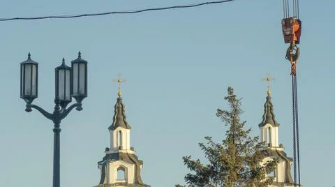 Red hook of a crane on the background of the tower church with orthodox cross Stock Photos