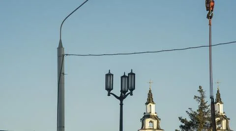 Red hook of a crane on the background of the tower church with orthodox cross Stock Photos