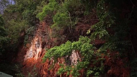 Red horizontal striations in sandstone rock cliff wall. Thailand. Stock Footage 83214659