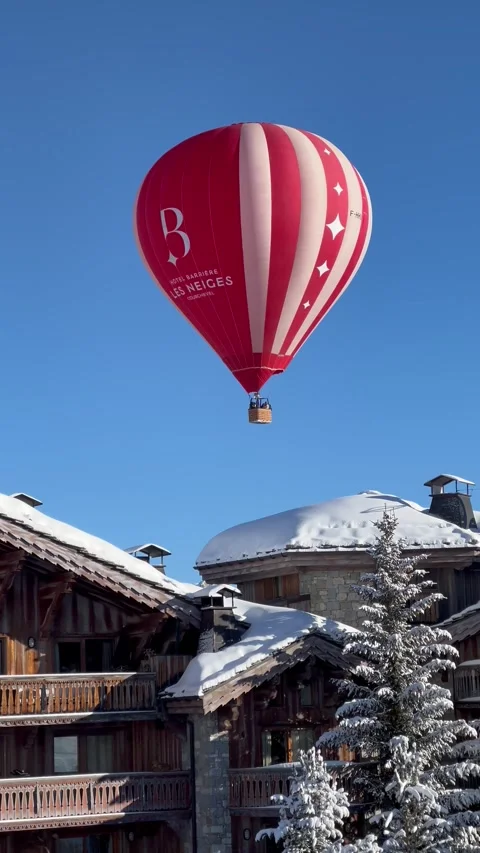 Red hot air balloon flying over ski resort in French alps Stock Footage 337061007