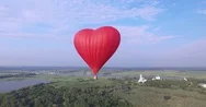 Red Hot Air Balloon In The Shape Of A Heart In The Air. View Around, Aerial Stock Footage