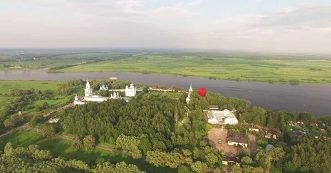 Red hot air balloon in the shape of a heart in the air. View around, aerial Video stock 71213620