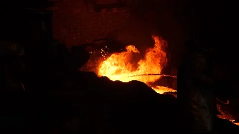 A red-hot cast iron flows through the gutter of the blast furnace. Stock Footage 151635617