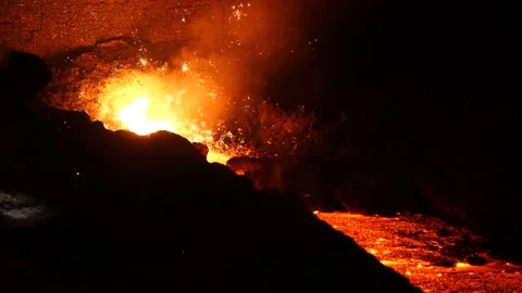 A red-hot cast iron flows through the gutter of the blast furnace Stock Footage 151635626