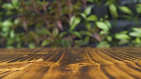 Red hot chili pepper falling on wooden table slow motion. Close up fresh Stock Footage 99174394