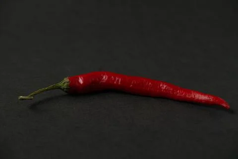 Red hot chilli on the dark table Stock Photos