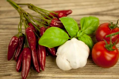 Red hot chilli pepper with basil and garlic on table Foto stock