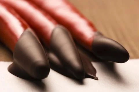 Red hot chilli pepper with dark chocolate Stock Photos