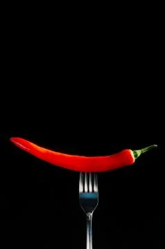 Red hot chilli pepper on fork Photos