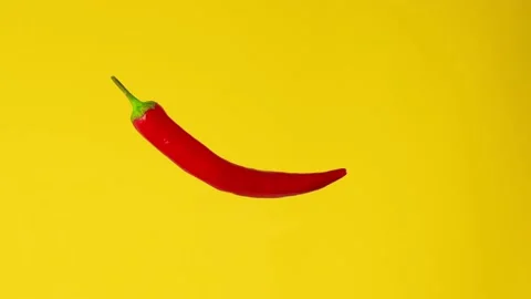 Red hot chilli pepper isolated rotating on a yellow background. Looped rotation Stock Footage 198048610