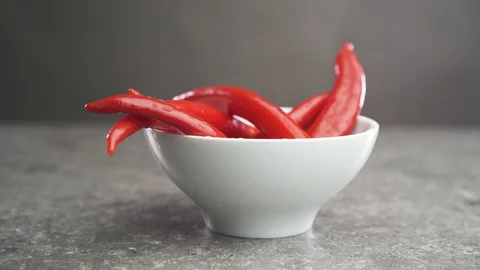 Red hot chilli pepper rests on a plate Stock-Footage 129062916
