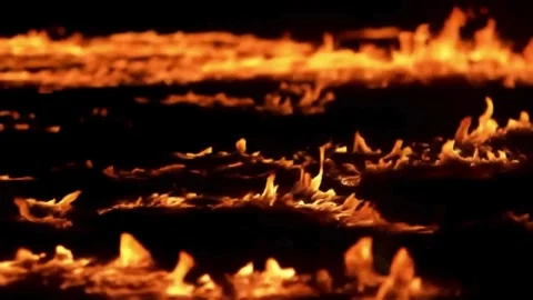 Red hot flames blaze in the dark, an abstract inferno of burning energy. Video stock 310644443