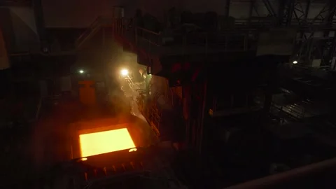 Red-hot sheet of newly-pressed steel emerging from rolling machine. Stock Footage 177423361
