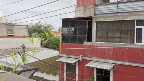 Red house big windows vegetation bright sky cloudy clouds poor country third Stock Footage 287892620
