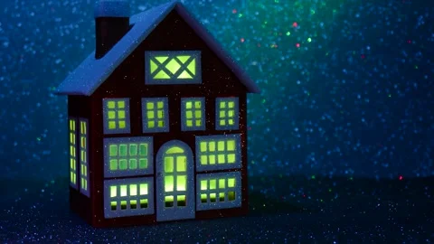 Red house with multi-colored glowing windows Stock Footage 265005906