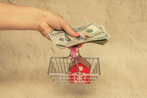 Red house with a stack of dollar bills. The concept of buying a house. Foto stock