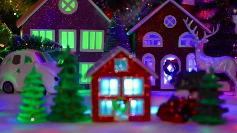 Red house surrounded by Christmas trees and a red car Stock Footage 292923927