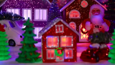 Red house surrounded by Christmas trees against en evening Christmas town Stock-Footage 292923934