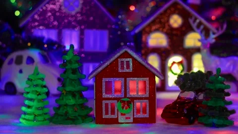 Red house surrounded by Christmas trees against of an evening Christmas town Stock Footage 292923959