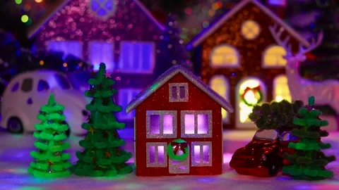 Red house surrounded by Christmas trees against of an evening Christmas town Stock Footage 292923964