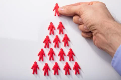 Red Human Figures Arranged In Triangular Shape Stock Photos
