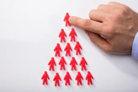 Red Human Figures Arranged In Triangular Shape Stock Photos