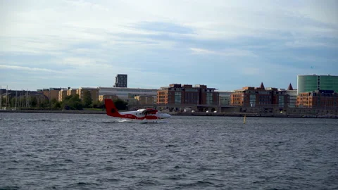 Red hydroplane floating on the water in front of the city 動画素材 168537642