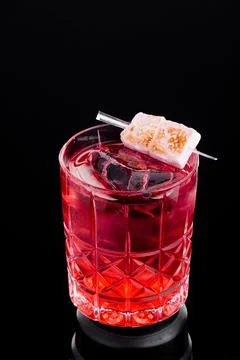 Red ice cocktail decorated with marshmallows in beautiful glass isolated on Stock Photos