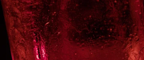 Red ice cube rotate on dark background macro shot Stock Footage 106007524