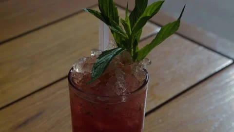 Red Iced Drink with Mint Garnish on Wooden Table at Bar in Sydney, Australia Stock Footage 345806276