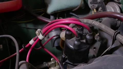 Red Ignition Spark Plug Wires Connected to Distributor in Engine Stock Footage 335643120