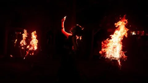 Red illuminated dancer framed by intense darkness Stock Photos