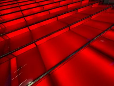 Red illuminated steps reflect a modern architectural design Stock Photos