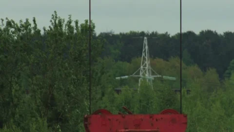 Red industrial crane hook foreground blur, heavy-duty lifting equipment Stock Footage 335763148